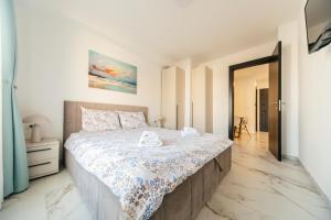 une chambre avec un grand lit dans une pièce dans l'établissement Harizma apartmani - Avenija, à Kragujevac