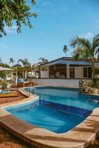 a swimming pool in front of a house at Hotel Boutique Evana in Acapulco