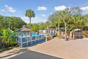 a playground with a gazebo and palm trees at Folliday Inn - The Runabout - Room 12 in Folly Beach +32 photos