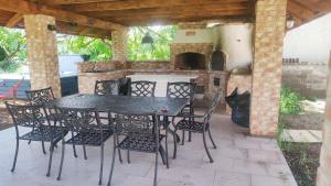 a patio with a table and chairs and a fireplace at Apartmán Šumiac 3 in Šumiac