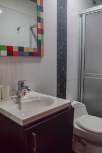 a bathroom with a sink and a toilet at Apartamento amoblado en Guatape in Guatapé +7 photos