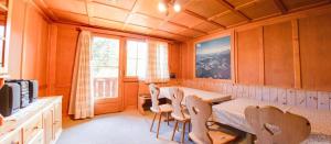 a kitchen with a table and chairs in a room at Chalet Suveran 2 in Arosa