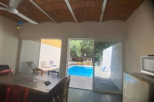 a dining room with a table and a swimming pool at C11 · Casa 2 niveles, alberca y vista al manglar in La Peñita de Jaltemba