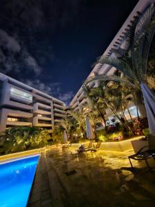 a large building with a swimming pool next to a hotel at Sheraton Ocean 103 - Without Pool access in Cairo