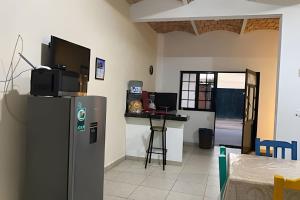 a kitchen with a refrigerator and a table at C12 · Casa 2 niveles, alberca y vista al manglar in La Peñita de Jaltemba