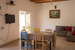 a dining room with a table and chairs and a couch at C7 Casas la colmena a 3 min playa alberca 4 rec, in La Peñita de Jaltemba