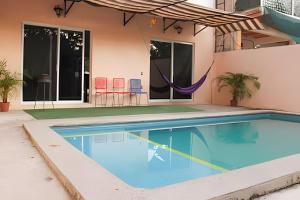 a swimming pool in front of a house at C7 Casas la colmena a 3 min playa alberca 4 rec, in La Peñita de Jaltemba