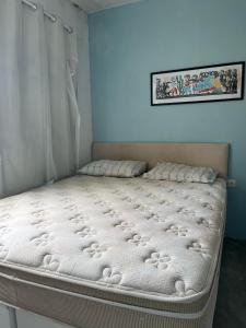 a bed in a room with a white mattress at Casa com Piscina em Enseada in Cabo de Santo Agostinho +38 photos