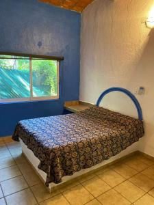 a bedroom with a bed in a room with a window at C1A 5 Alberca privada a 5 min de la playa in La Peñita de Jaltemba +62 photos