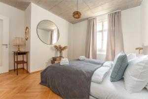 a bedroom with a bed and a mirror in it at Oomph Apartments in Prague