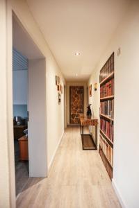 a hallway with a book shelf and a table at Ferienwohnung Rose in Walkenried
