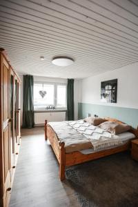 a bedroom with a large bed with a wooden ceiling at Ferienwohnung Rose in Walkenried