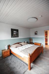 a bedroom with a large wooden bed and a ceiling at Ferienwohnung Rose in Walkenried