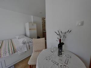 a bedroom with a table and a bed and a table and chairs at Studio Ivanka in Jurandvor