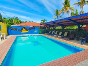 a swimming pool at a resort with blue water at Las Catalinas Coronado in Playa Coronado
