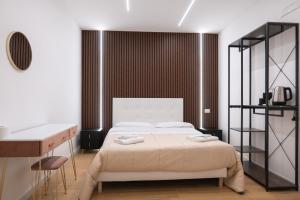 a bedroom with a bed with two towels on it at Relais San Demetrio - Modern & Central rooms in Salerno +72 photos