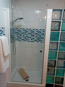 a bathroom with a shower with a glass door at Casa Patricia II in Arcos de la Frontera +5 photos