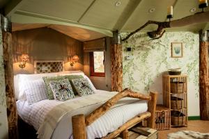 a bedroom with a bed in a room with wallpaper at The Oak Tree House in Westport