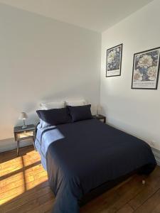 En eller flere senge i et værelse på Appartement centre ville