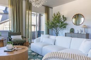 a living room with a white couch and a table at The Copperleaf Flagstaff Escape in Flagstaff