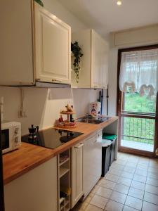 a kitchen with white cabinets and a counter top at La casa di Camilla in Perledo