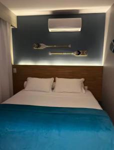 a bedroom with a large white bed with a blue blanket at Prestes Exclusive - Pipa Ubaia in Pipa +18 photos