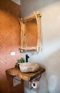 a bathroom with a stone sink on a wooden shelf at Villas del Valle Sagrado in Cusco +125 photos