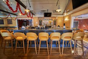 a bar with a row of stools in a restaurant at Seaport Resort and Marina in Fairhaven