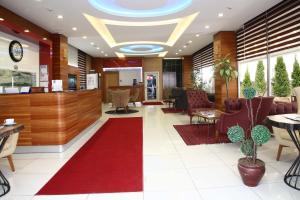 a lobby of a hotel with a red carpet at Hotel Avcilar City in Avcılar