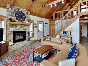 a living room with a fireplace and a clock at Howling Wolf Den in Oakland