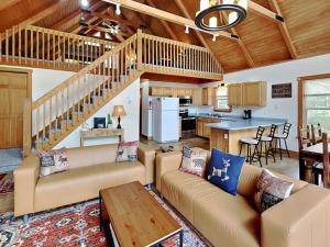 a living room with couches and a kitchen at Howling Wolf Den in Oakland +30 photos