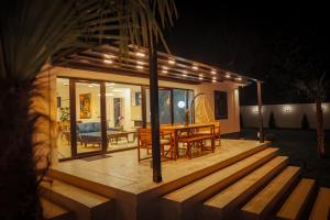 a house with a wooden deck with a table and chairs at The Crown Pool Villa in Belgrade