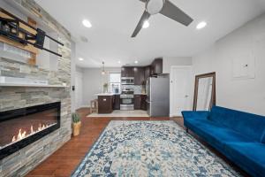 a living room with a blue couch and a fireplace at NYNJ World Cup 26 Fan Zone Queens Kasa Boho Rentals Sleeps 4 persons in Brooklyn Manor