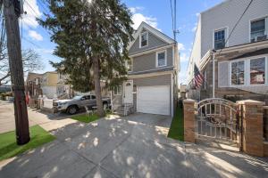 a house with a car parked in a driveway at NYNJ World Cup 26 Fan Zone Queens Kasa Boho Rentals Sleeps 4 persons in Brooklyn Manor