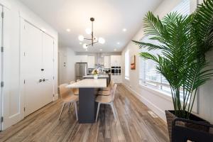 a kitchen and dining room with a table and chairs at Chic Hideaway-King Bed-Fireplace-DT-WEM-Garage in Edmonton