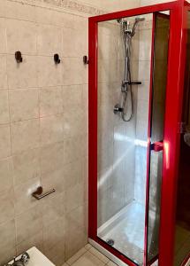a shower with a red frame in a bathroom at Appartamento sul Lago con Terrazza Panoramica in Riva di Solto +29 photos