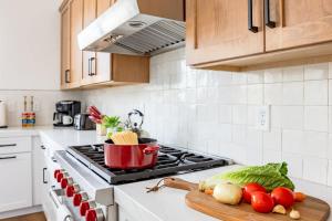 a kitchen with a stove with vegetables on a cutting board at Home with Studio near Pine Canyon in Flagstaff