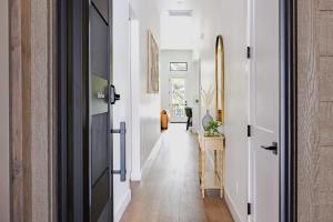 a hallway with white walls and a door at Home with Studio near Pine Canyon in Flagstaff