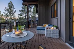 a patio with a table and wine glasses on a deck at Home with Studio near Pine Canyon in Flagstaff
