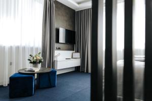 a hotel room with a bed and a table and a tv at Apartments Museum in Sarajevo