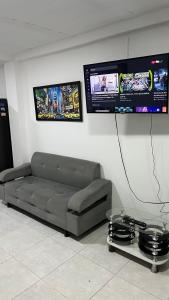 a living room with a couch and a tv at apartamento mirador el paraiso in Santa Rosa de Cabal