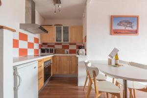 a kitchen with a table and chairs in a room at Appartement à 200 m from ThalassoSpa in Pornic