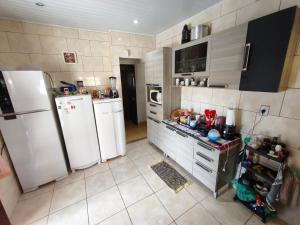 a kitchen with two refrigerators and a refrigerator at Recanto da Família in Cabo Frio