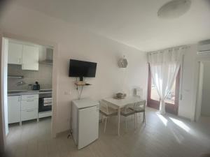 a kitchen with a table and a small table and chairs at A due passi dalla spiaggia in Vieste