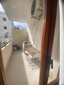 a balcony with chairs and tables on a building at A due passi dalla spiaggia in Vieste