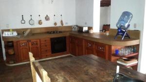 a kitchen with a wooden counter top and a table at Casa Mary Day in Villa de Leyva