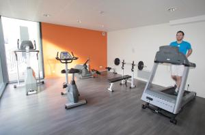 a man in a gym with several exercise equipment at Appart Hotel Odalys City Tours Le Jardin des Lettres in Tours