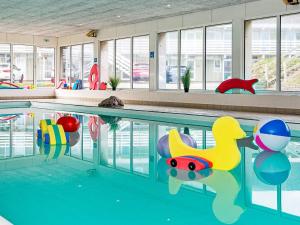 a swimming pool with toys in the water at 2 person holiday home in Ringkøbing in Ringkøbing