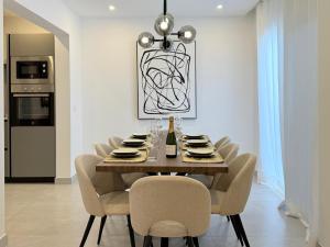 a dining room with a wooden table and chairs at Villa Tiffany in Puerto del Carmen
