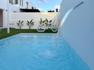 a water fountain in the middle of a swimming pool at Villa Tiffany in Puerto del Carmen